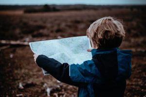 Walk Planning - little boy holding an os map